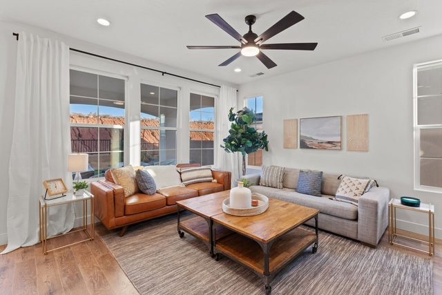 Living room seating with coffee table and red rock window views