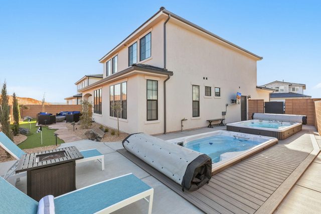 Rear exterior of Paseos 1308 with swim spas and putting green