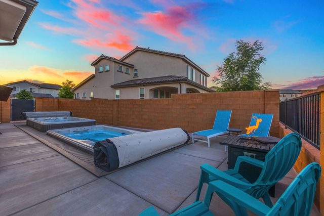 Swim spas, loungers and Adirondack chairs at sunset