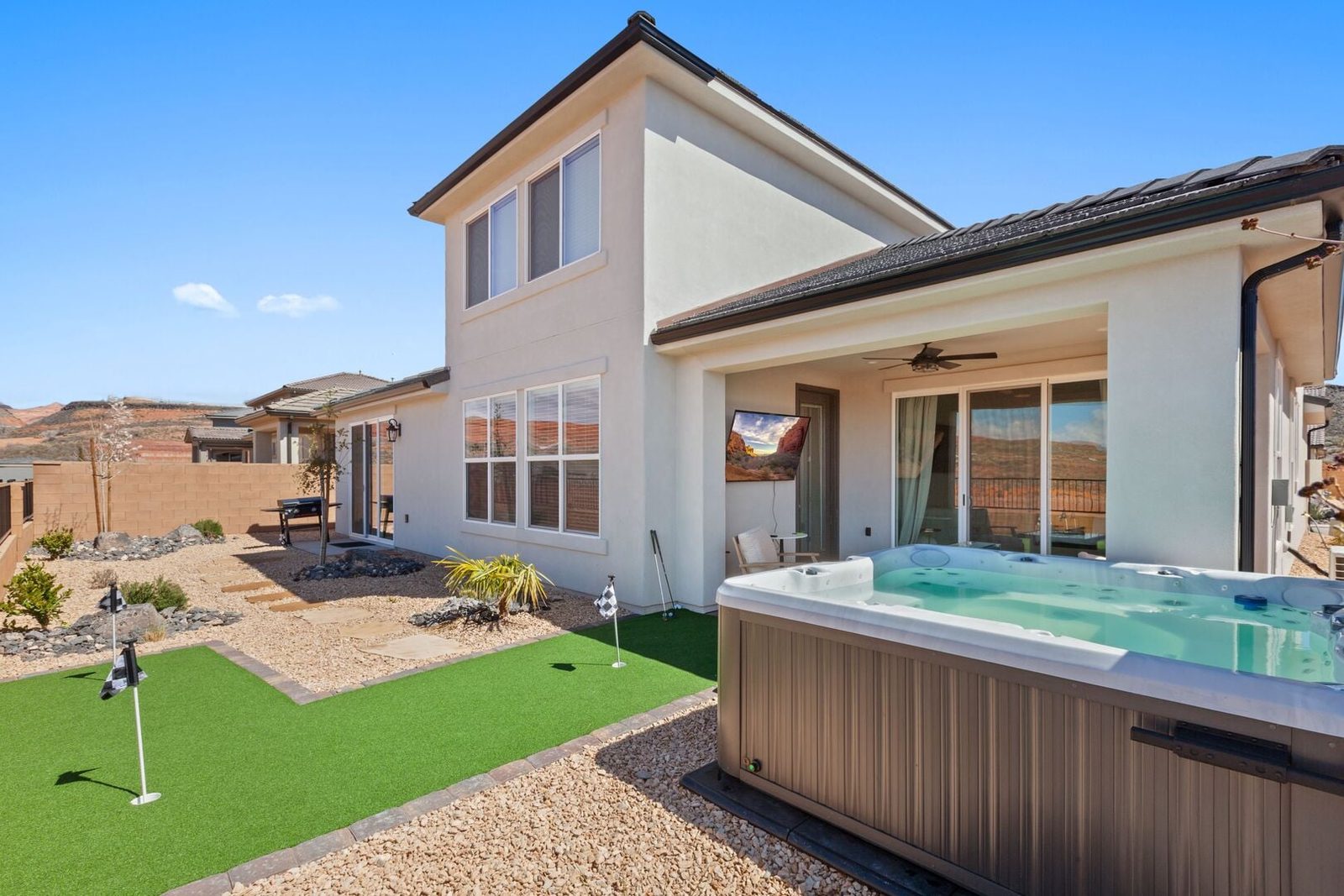Backyard hot tub and putting green behind Paseos 1317~Zion Dream