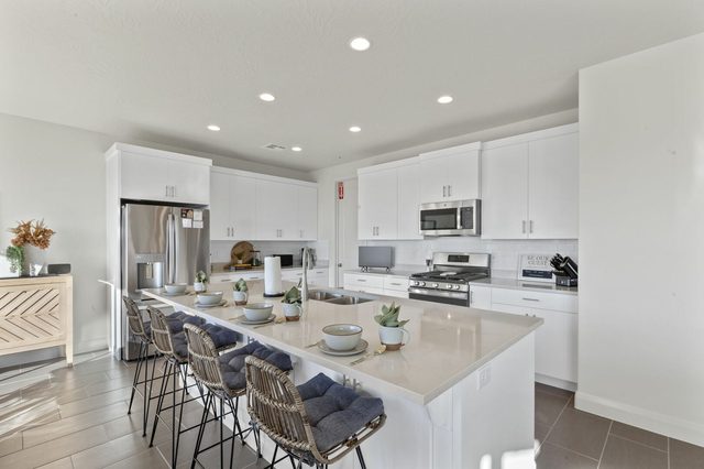 Kitchen island with bar seating for four and stainless appliances