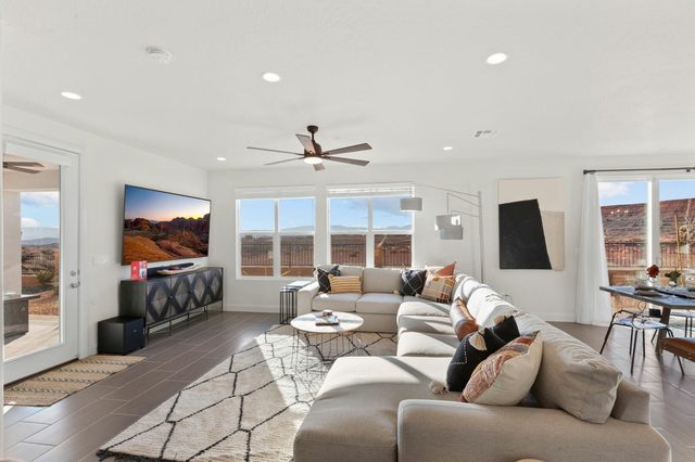 Main-level TV room with large sectional and wall TV