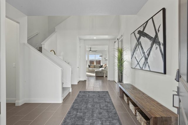 Entryway with bench, runner rug and staircase
