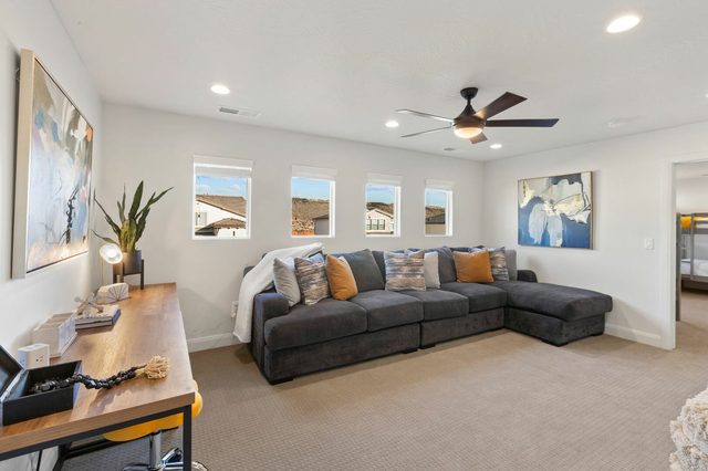 Upstairs TV room with sectional sofa and desk
