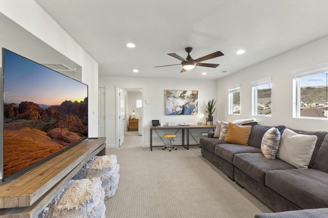Upstairs TV room with large TV and sectional seating