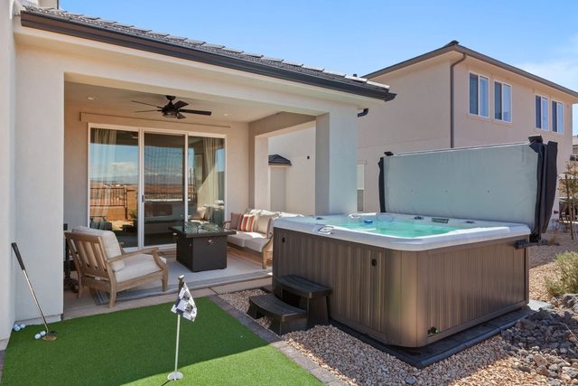 Private hot tub beside covered patio and putting green