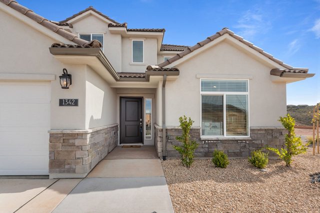 Front entry of Paseos 1342 with stone accents and garage