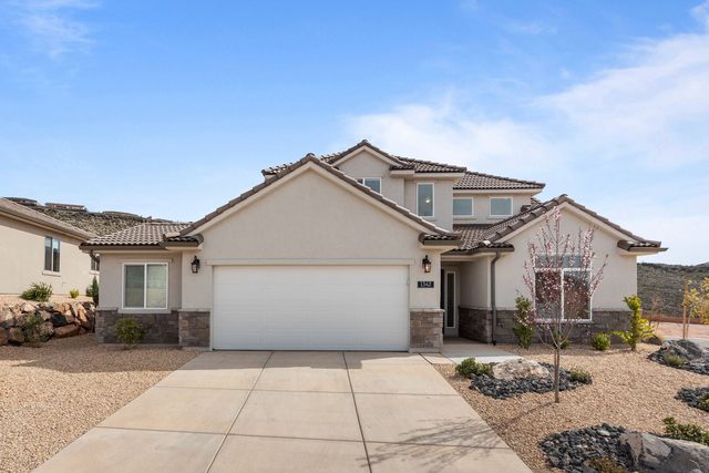 Two-story Paseos 1342 with two-car garage and driveway
