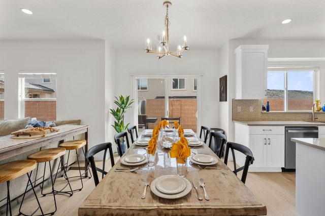 Long wood dining table with bar seating along the wall