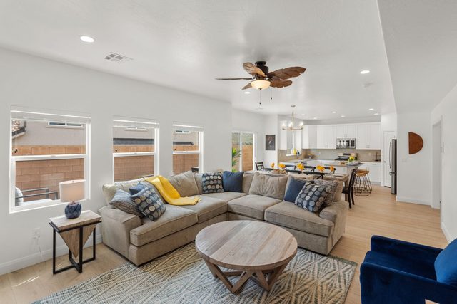 Open living room with sectional and round coffee table