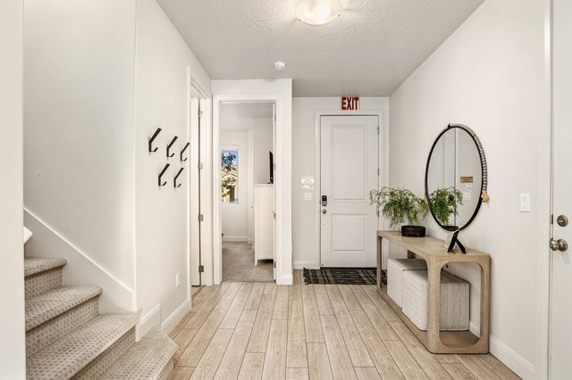 Entry hallway with coat hooks and round mirror