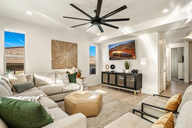 Living room with sectional sofa and mounted TV
