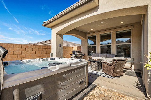 Private hot tub beside the covered back patio