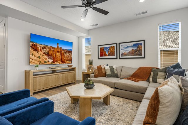 Living room sectional facing a large wall-mounted TV