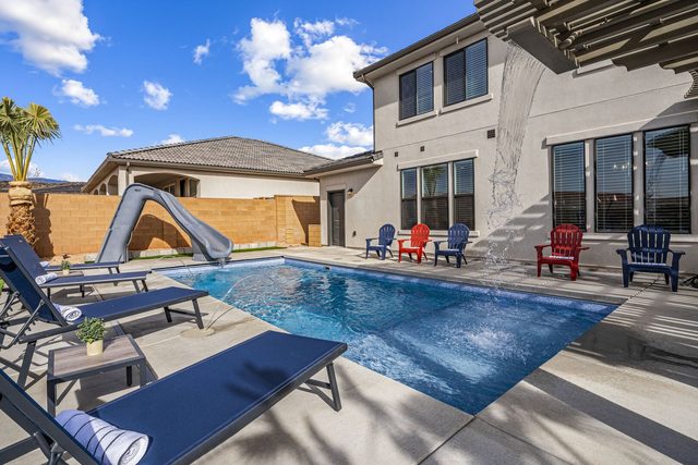 Private pool with slide and loungers beside house at Paseos 1373