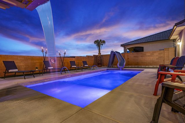 Private pool with waterfall and slide at dusk at Paseos 1373