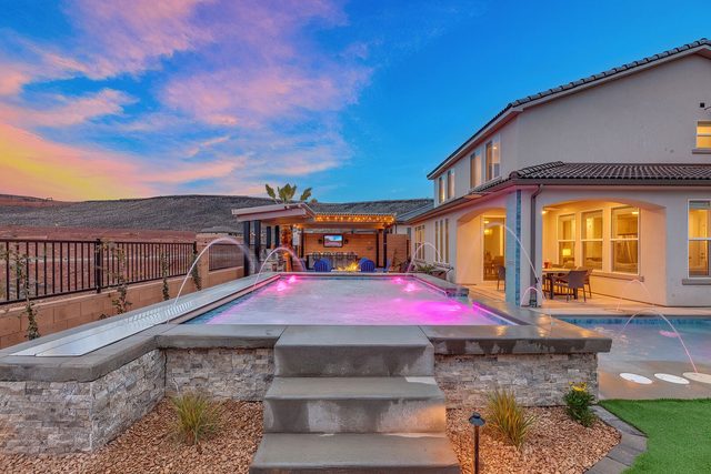 Raised pool with steps, fountains and the back of the house