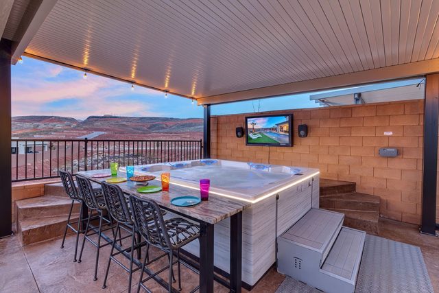 Hot tub with bar-height dining and outdoor TV under cover