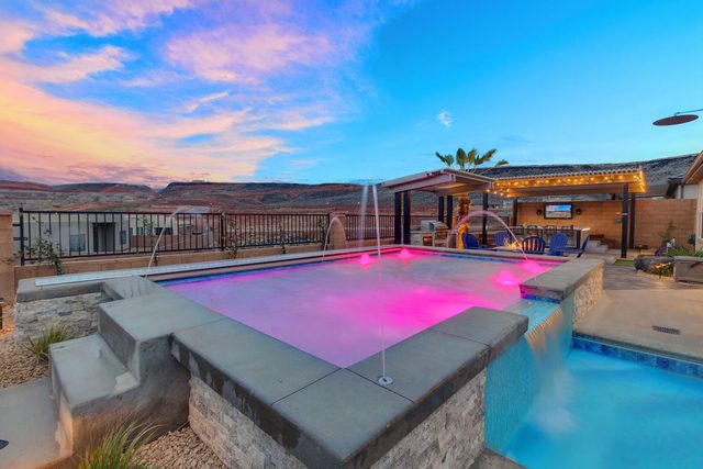 Raised pool spilling into the main pool at dusk