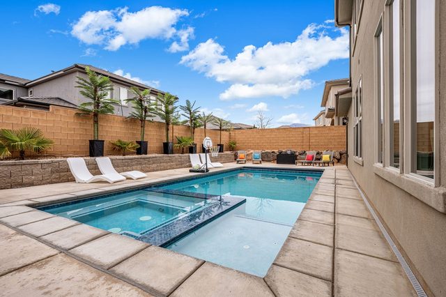 Private pool and hot tub along the side of the home
