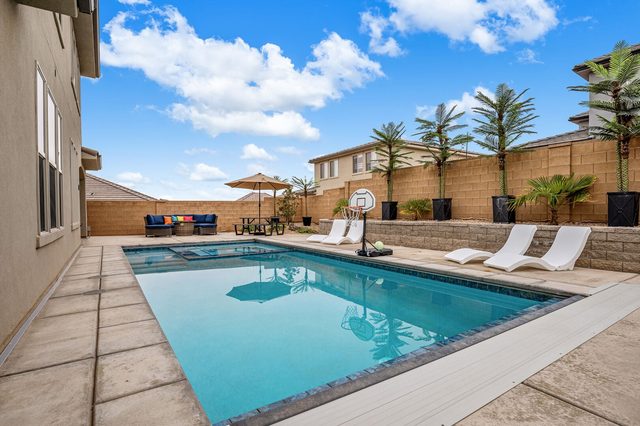 Long private pool with loungers and fire pit seating