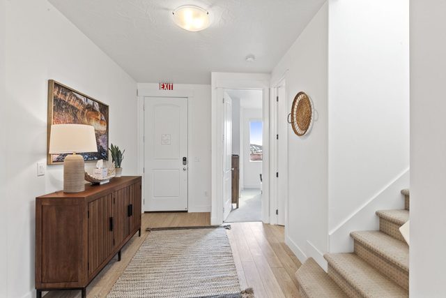 Entry hallway with console table and staircase to upper floor