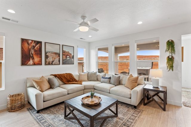 Great room with sectional sofa, coffee table and canyon artwork