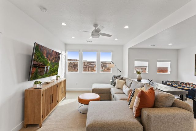 Upstairs loft lounge with sectional sofa and wall-mounted TV