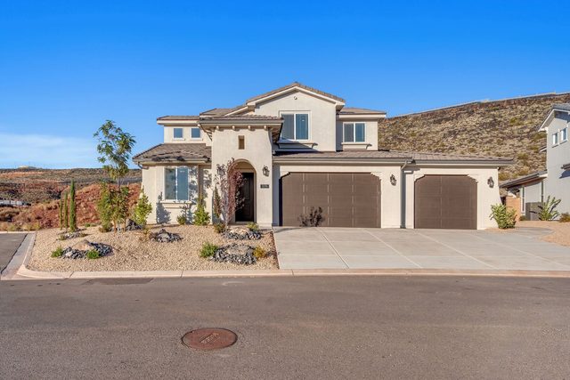Front of Paseos 1496 with three-car garage and desert landscaping