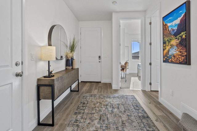 Entry hallway with console table, runner rug and red rock art