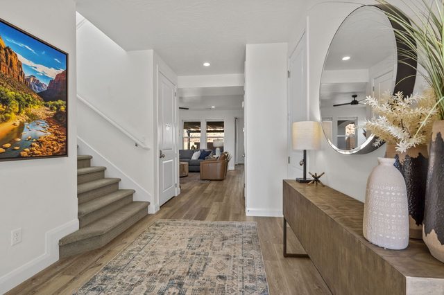 Entry foyer with staircase and view toward the living room