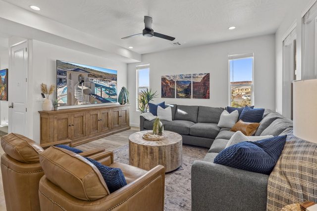 Living room seating with wall-mounted TV and wood console