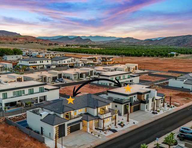 Aerial view of both side-by-side homes at Pecan Valley 5161/5173 Retreat at sunset
