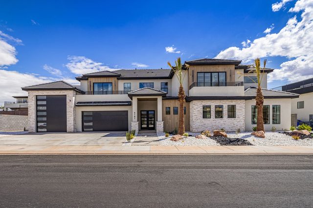 Front of home 5161 with two-car garage and palm trees