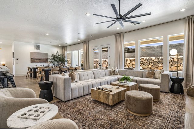 Open living room with large sectional sofa and ceiling fan in home 5161