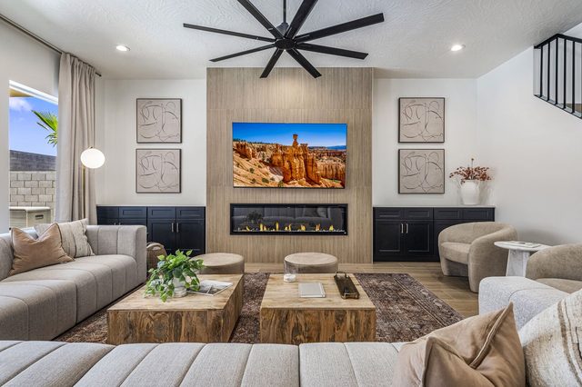 Living room with linear fireplace, wall TV and sectional seating