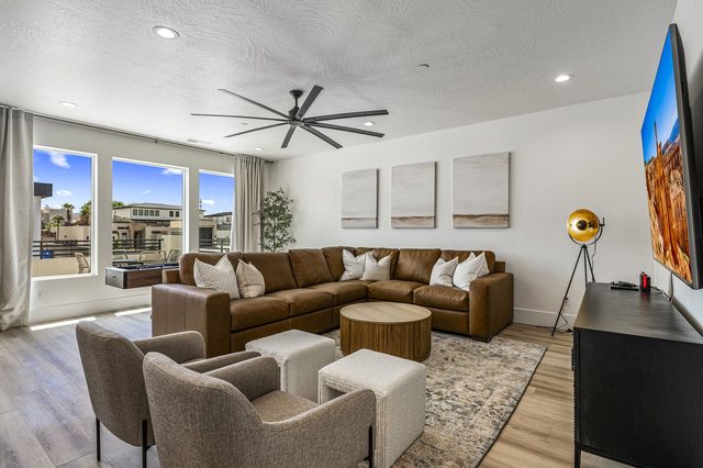 Upstairs loft lounge with leather sectional and wall TV in home 5161