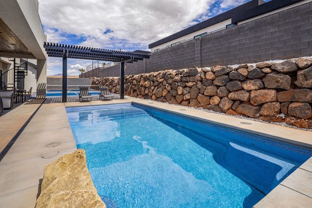 Private pool with pergola and rock retaining wall at home 5161
