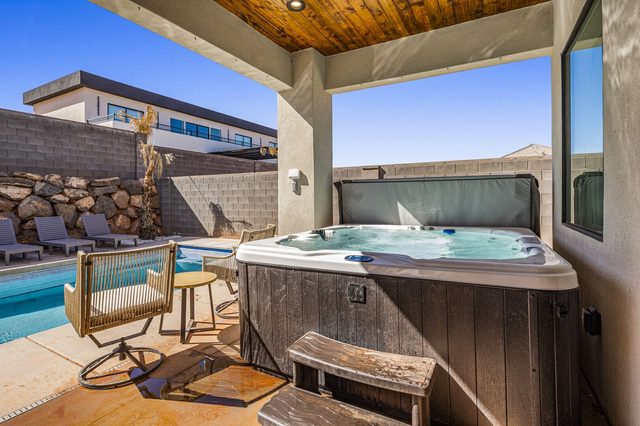 Private hot tub on covered patio beside the pool at home 5173