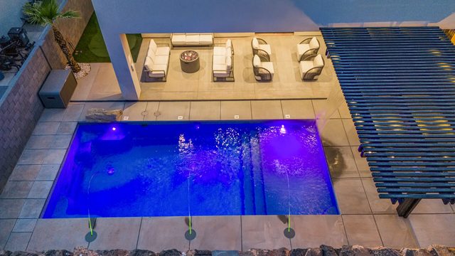 Overhead view of the lit private pool and patio lounge