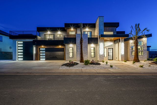 Modern two-story front exterior of Pecan Valley 5173 lit at dusk