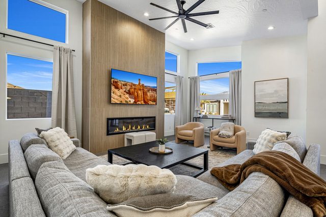 Living room with sectional sofa and linear fireplace at Pecan Valley 5173