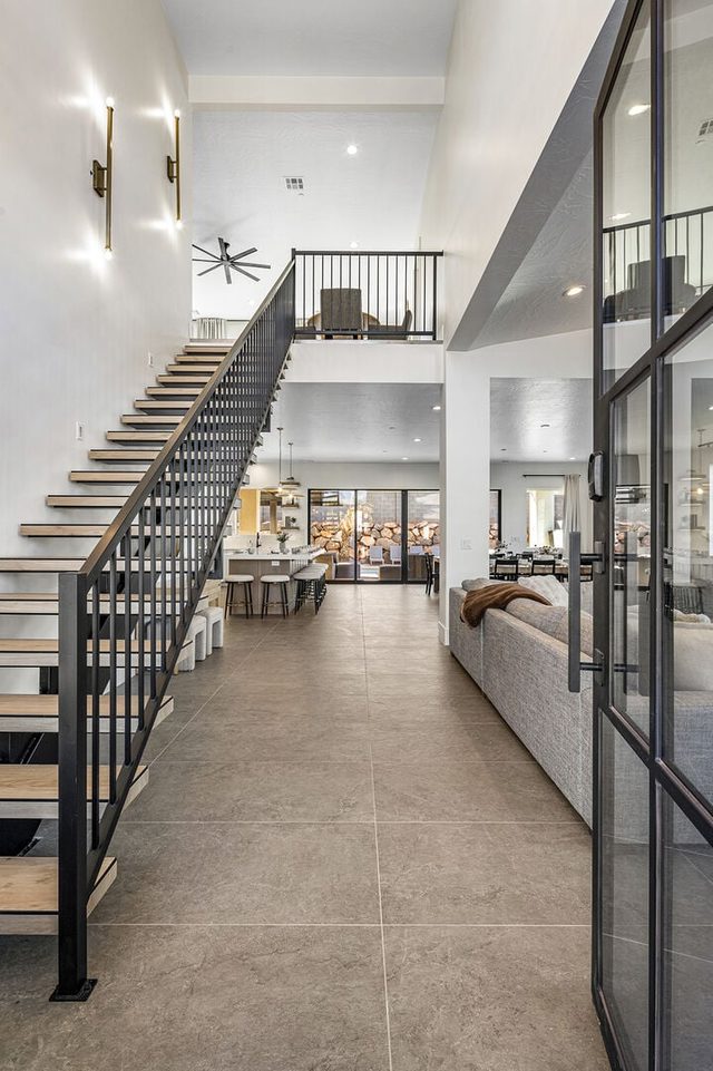 Entry hallway with open staircase and glass-paneled doors