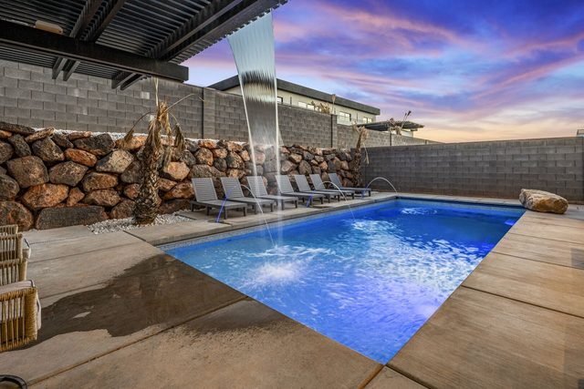 Private pool with sheer waterfall feature at sunset