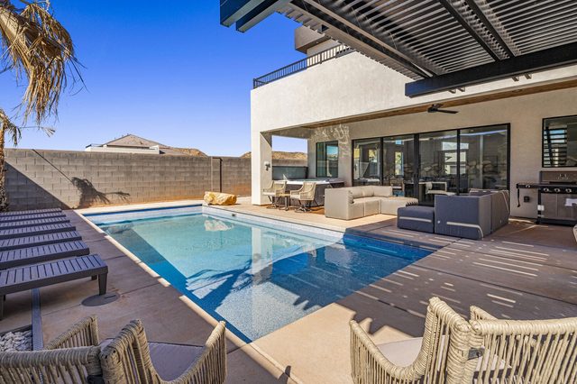 Private pool and covered patio seen from the backyard