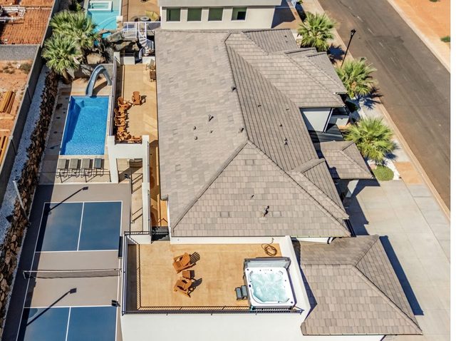 Aerial view of Pecan Valley 5193 roof, private pool, pickleball court and hot tub deck