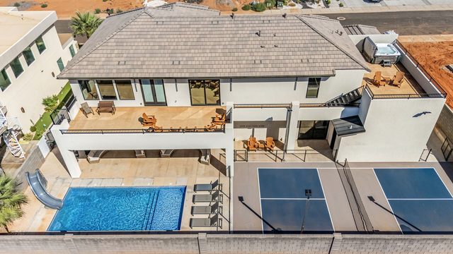 Aerial of backyard pool, deck and pickleball court at Pecan Valley 5193