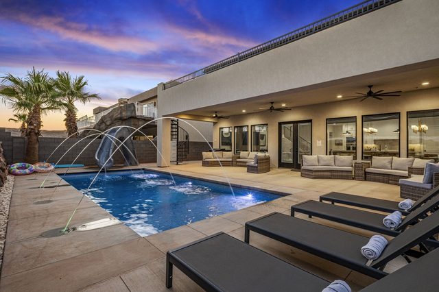 Private pool with fountain jets and covered patio lounge at Pecan Valley 5193