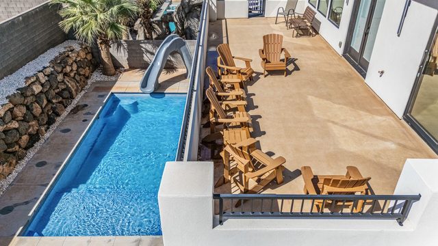 Aerial view of private pool with slide and balcony at Pecan Valley 5193