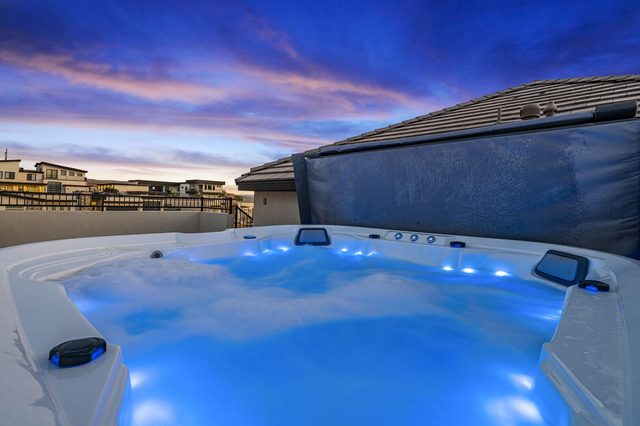 Hot tub lit blue at dusk on the deck at Pecan Valley 5193